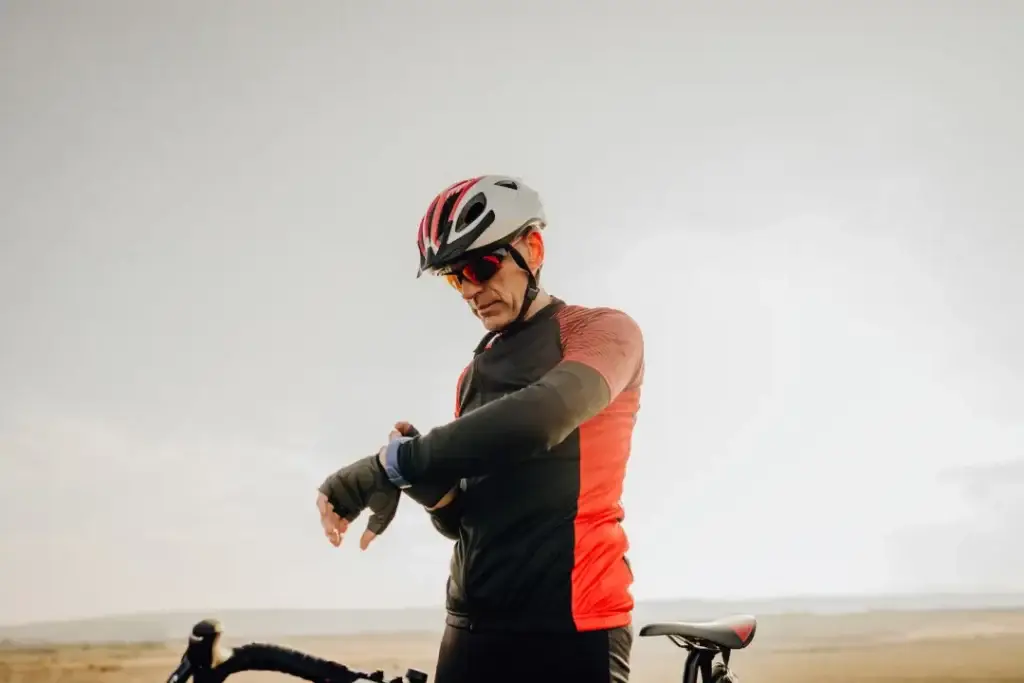 male-cyclist-checking-watch-611a6b3